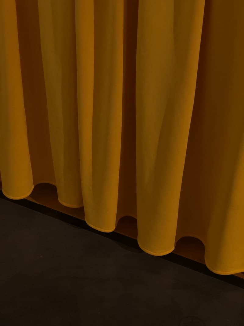 Yellow curtain on brown wooden floor